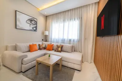 a living room with a couch and a table at Chic Beachfront Studio Appartment in Oulad Akkou