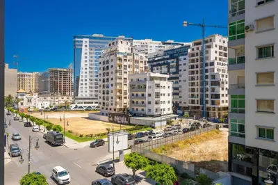 a city with tall buildings and a street with cars at Chic Beachfront Studio Appartment in Oulad Akkou