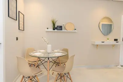 a dining room with a table and chairs at Chic Beachfront Studio Appartment in Oulad Akkou