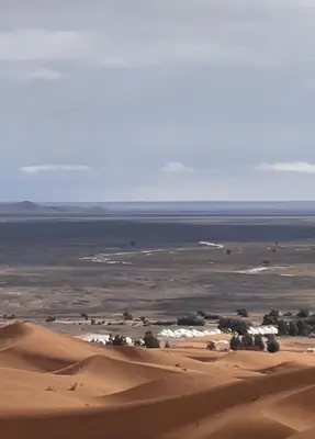 a view of a desert with a body of water at sahara desert camp in Merzouga