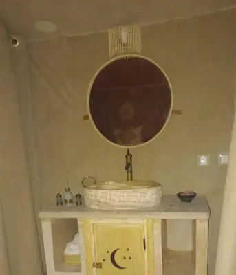 a bathroom with a sink and a mirror at Merzouga Dream Camp in Merzouga