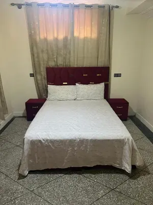 a bedroom with a large bed with a red headboard at Étage dans une villa avec piscine partagée Meknès in Meknès