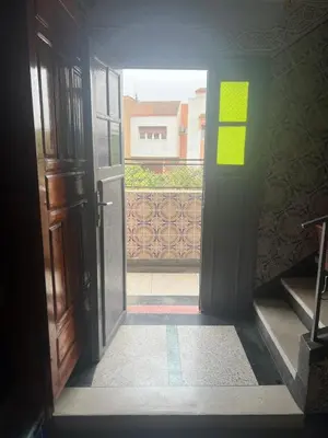 an open door with a view of a balcony at Étage dans une villa avec piscine partagée Meknès in Meknès