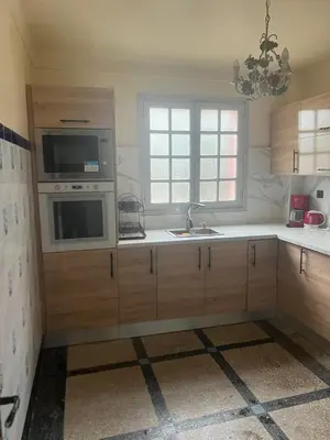 a kitchen with a sink and a microwave at Étage dans une villa avec piscine partagée Meknès in Meknès