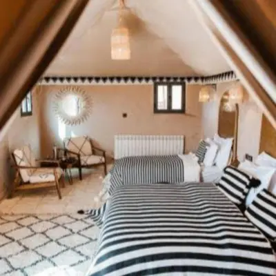 a bedroom with a large bed in a attic at Best Merzouga traductional camp in Merzouga