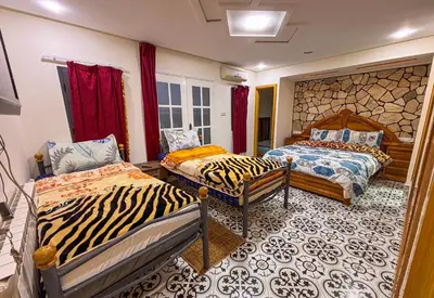 a bedroom with two beds with zebra print at Gite Atlas Tigrigra