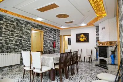 a dining room with a table and chairs and a fireplace at Gite Atlas Tigrigra