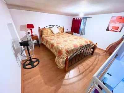 a bedroom with a bed and a table with a lamp at ZenStay Residences Modern Apartments Near City Center With Balcony And Wifi in Fès