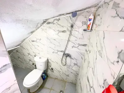 a bathroom with a toilet and a shower at ZenStay Residences Modern Apartments Near City Center With Balcony And Wifi in Fès