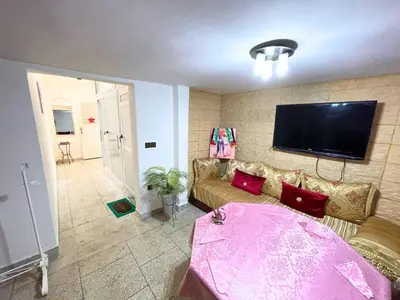 a living room with a couch and a flat screen tv at ZenStay Residences Modern Apartments Near City Center With Balcony And Wifi in Fès