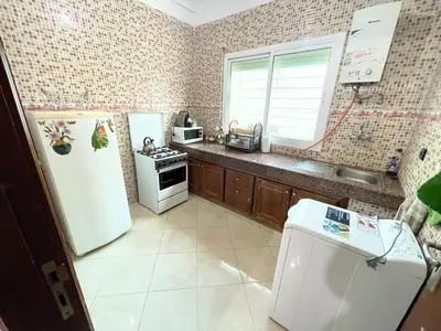 a kitchen with a white refrigerator and a sink at ZenStay Residences Modern Apartments Near City Center With Balcony And Wifi in Fès