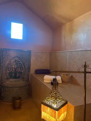 a bathroom with a tub and a shower with a sink at Private pool villa & garden Marrakech in Marrakech