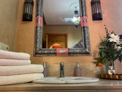 a bathroom with a sink and a mirror at Private pool villa & garden Marrakech in Marrakech