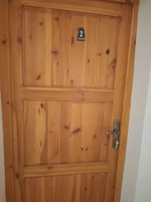 a wooden door with the number on it at Kasbah Anisi