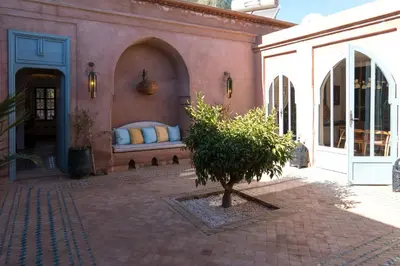a building with a bed with pillows on it at Villa Riad Marrakech in Najem