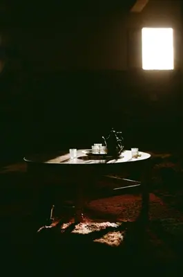 a dark room with a table with cups on it at Authentic Sahara with Locals in Tagounite