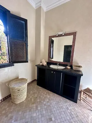 a bathroom with a sink and a mirror at Villa Atika - Maison d'Hôtes & SPA in El Bougaria