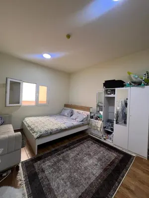 a bedroom with a bed and a refrigerator at altijan