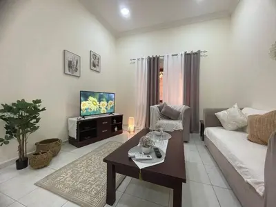 a living room with a couch and a tv at altijan