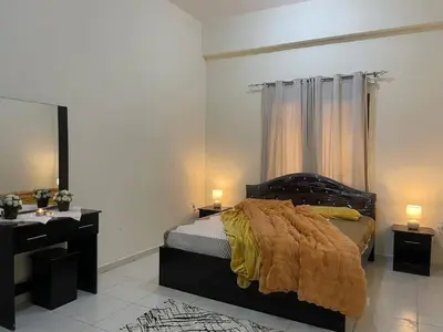 a bedroom with a bed and a desk with two lamps at altijan