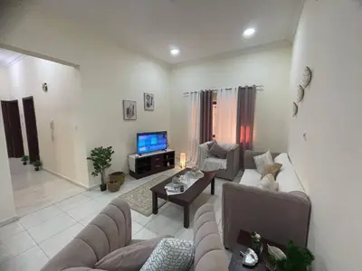 a living room with two couches and a television at altijan