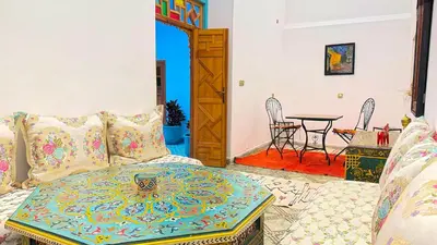 a living room with a couch and a table at Dar Fayrouz in Fès