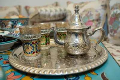 a silver tea pot on a plate on a table at Dar Fayrouz in Fès