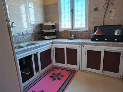 a kitchen with a counter with a sink and a rug at taddart in Merzouga
