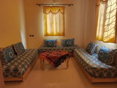 a living room with two couches and a table at taddart in Merzouga