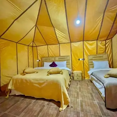 a bedroom with two beds in a tent at Luxury camp in Merzouga