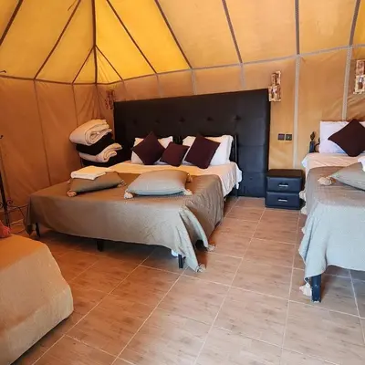 a bedroom with two beds in a tent at Luxury camp in Merzouga