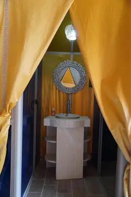 a bathroom with a sink and a mirror at Ousaadi luxury desert camp in Merzouga