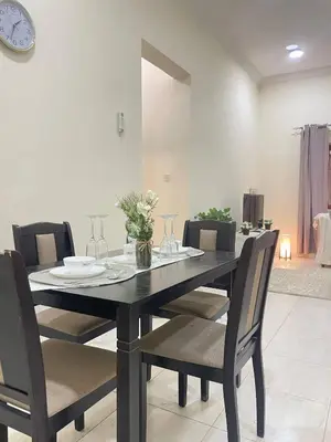 a dining room table with chairs and a clock on the wall at altijan