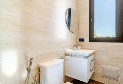 a bathroom with a white toilet and a sink at Villa Dar Jannat Marrakech in Aït Namous