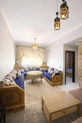 a living room with two beds and a couch at Fes Saiss Residence in Fès