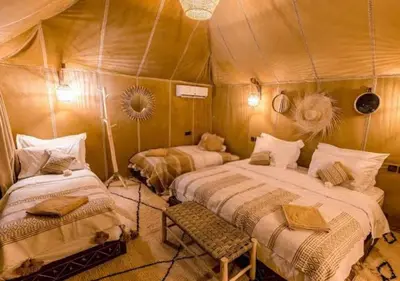 a bedroom with two beds in a tent at Merzouga Atlantis in Merzouga