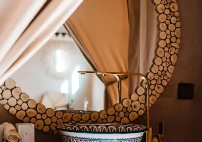 a bathroom with a large mirror and a tub at Merzouga Atlantis in Merzouga