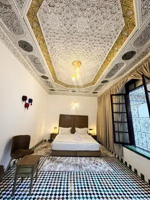 a bedroom with a bed and a coffered ceiling at Riad Azul Fes & SPA in Fès