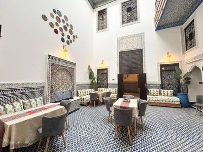 a room with tables and chairs in a building at Riad Azul Fes & SPA in Fès