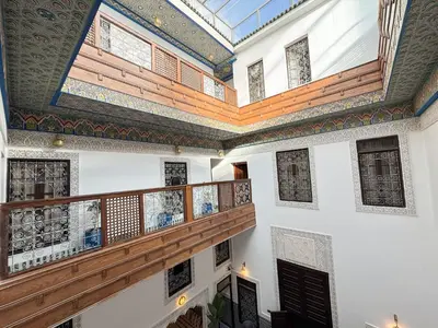 a room with a balcony and a wooden staircase at Riad Azul Fes & SPA in Fès