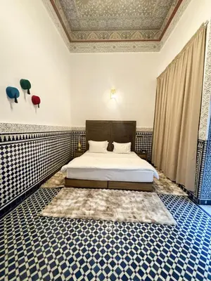 a bedroom with a bed with blue and white tiles at Riad Azul Fes & SPA in Fès