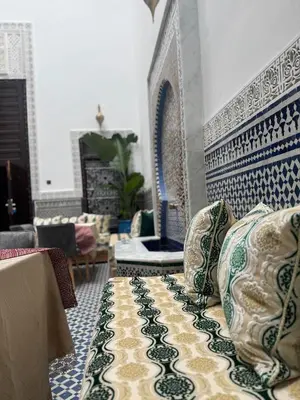 a living room with blue and white tiles on the wall at Riad Azul Fes & SPA in Fès