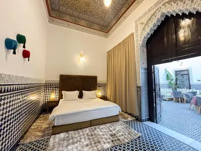 a bedroom with a bed in a room with a ceiling at Riad Azul Fes & SPA in Fès