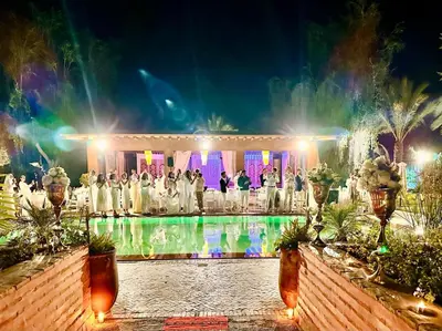 a wedding ceremony in front of a pool at night at Villa Ishtar in Marrakech
