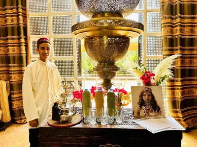 a man standing next to a table with a large vase at Villa Ishtar in Marrakech