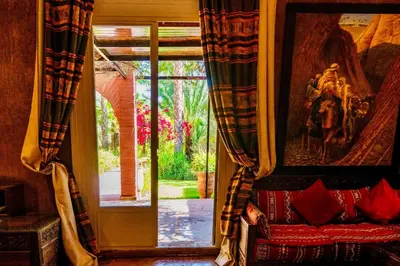 a room with a window and a couch in front of a door at Villa Ishtar in Marrakech