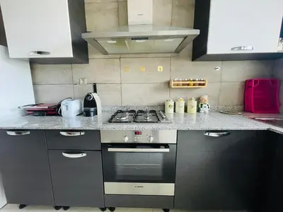 a kitchen with a stove and a counter top at Résidence chic et sécurisé - 2 chambres à Prestigia in Fès