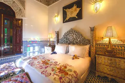 a bedroom with a bed with flowers on it at Riad Fes Maya suite & spa in Fès