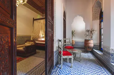 a hallway with a room with a bed and a table at Riad Fes Maya suite & spa in Fès