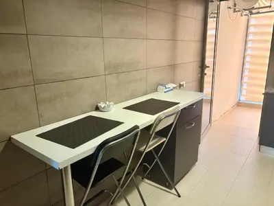 a small kitchen with a table and chairs at Résidence Prestigia Fès centre - 3 chambres in Fès